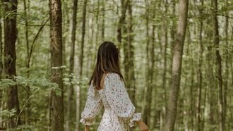 Vrouw loopt door bos