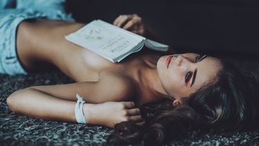 meisje ligt met een boek op haar borst